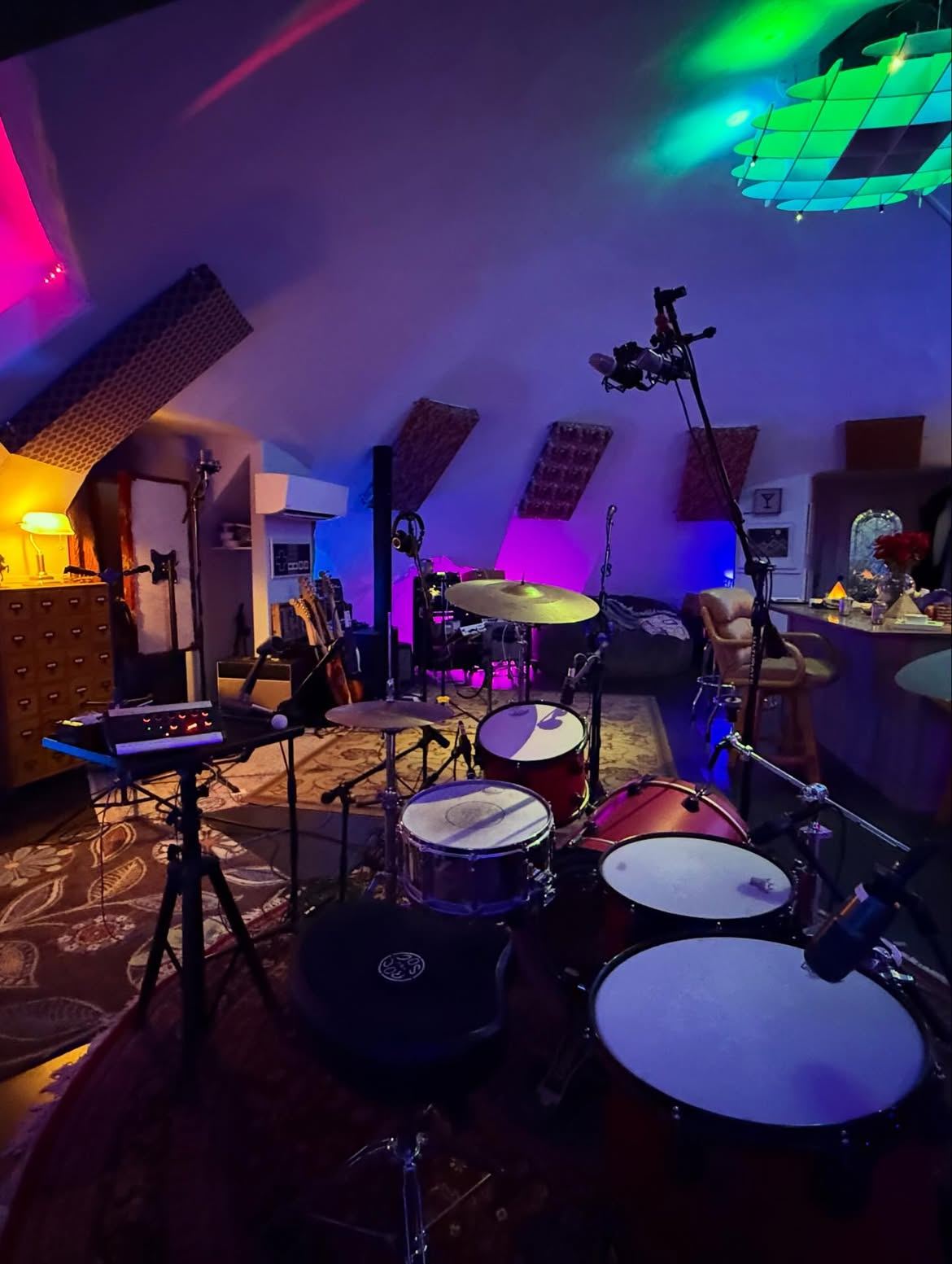 Drum kit set up under the curved dome ceiling in colored light